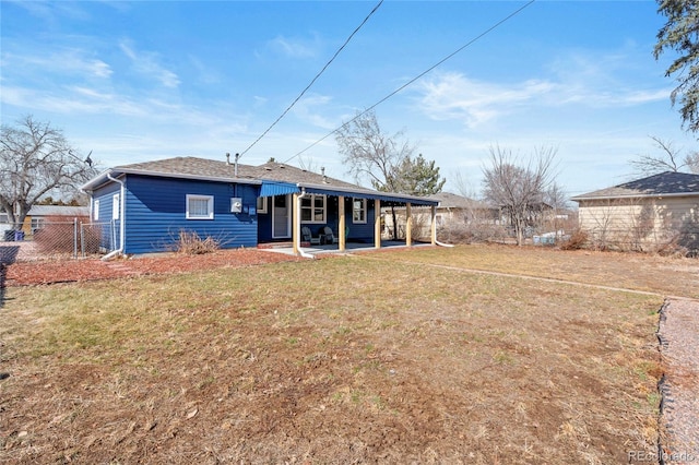 back of house with a patio area, fence, and a yard