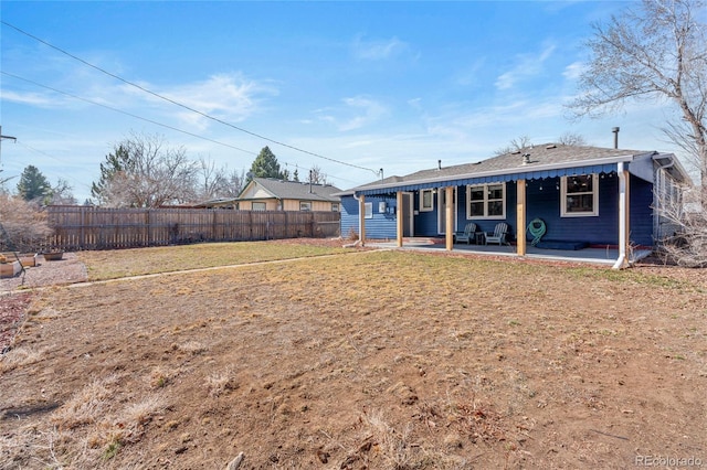 back of house with a patio area, fence, and a lawn