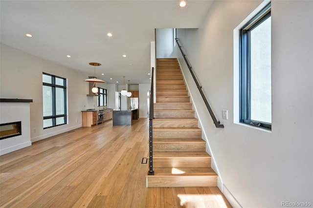 stairs featuring wood-type flooring