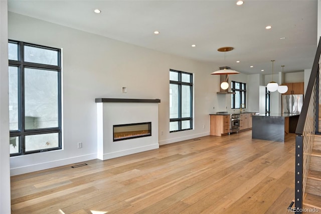 unfurnished living room with light hardwood / wood-style flooring