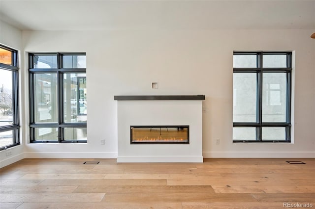 unfurnished living room featuring light wood-type flooring