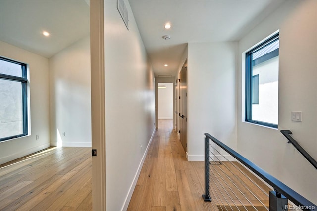 hall featuring plenty of natural light and light wood-type flooring