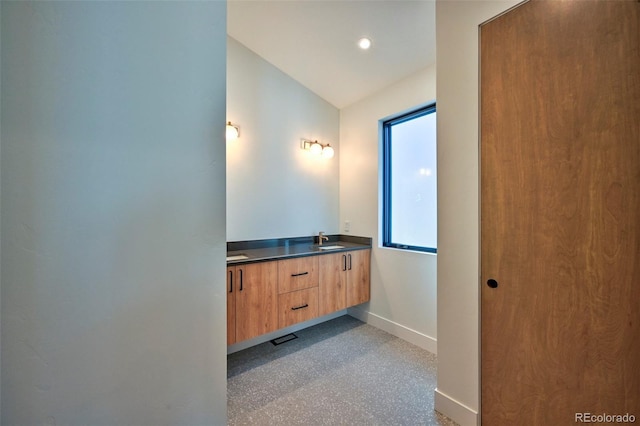 bathroom with vanity and vaulted ceiling