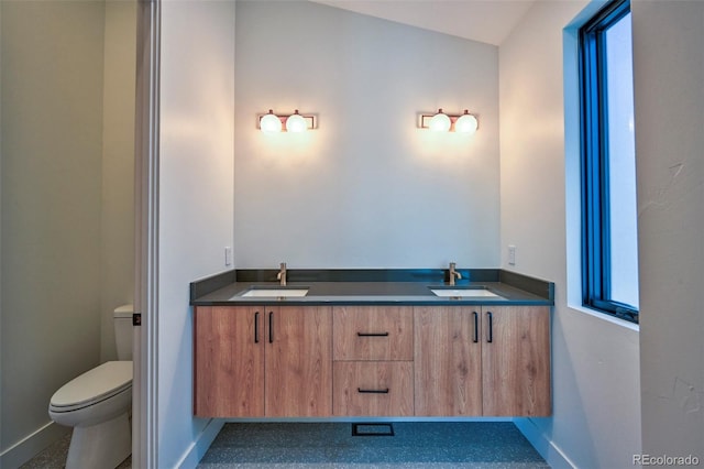 bathroom featuring vanity and toilet