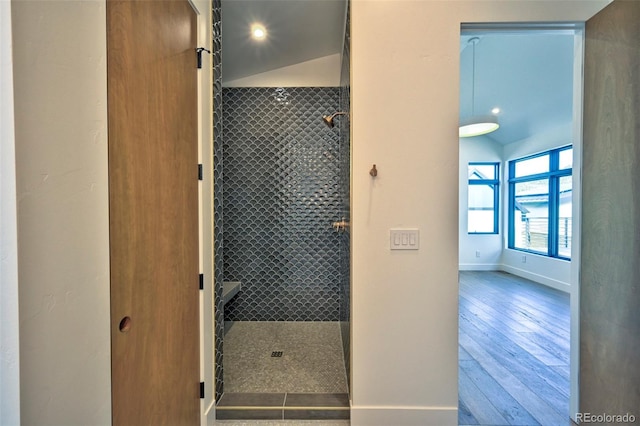 bathroom with lofted ceiling and wood-type flooring