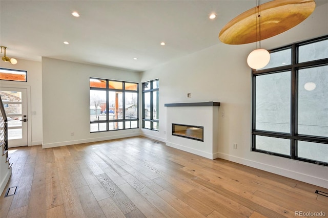 unfurnished living room featuring light hardwood / wood-style floors