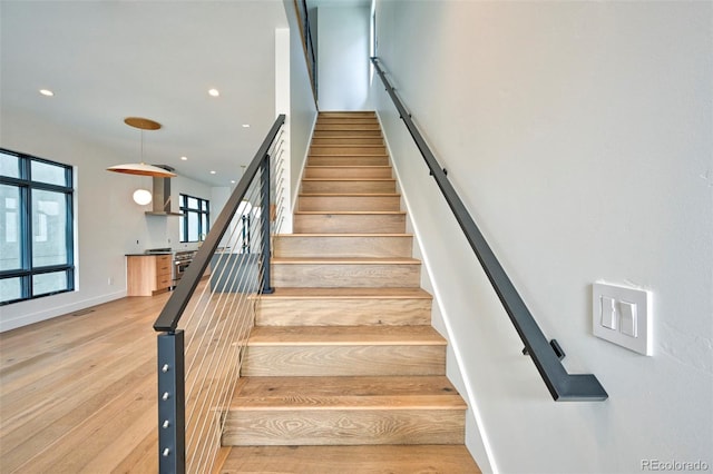 stairs featuring hardwood / wood-style flooring