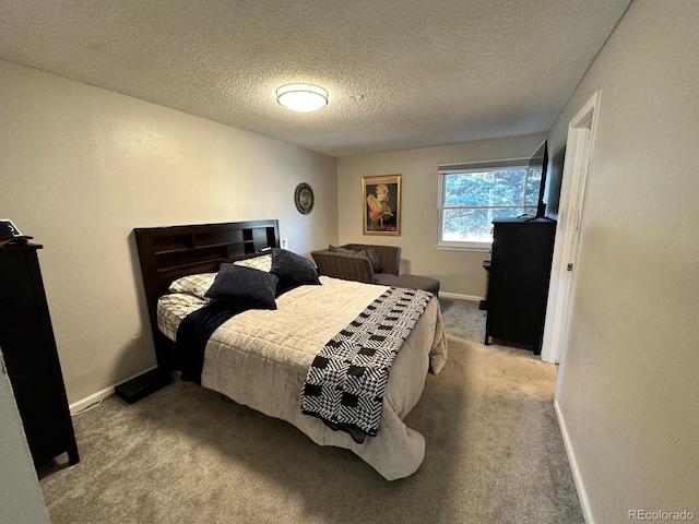 carpeted bedroom with a textured ceiling