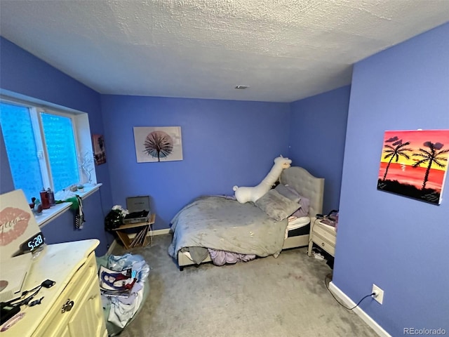 carpeted bedroom featuring a textured ceiling