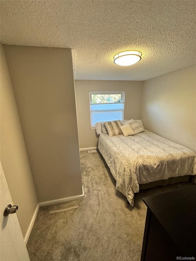 carpeted bedroom with a textured ceiling