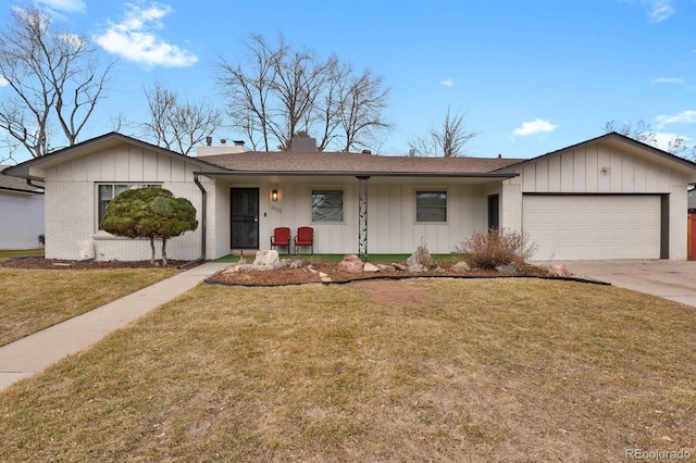 ranch-style home featuring brick siding, concrete driveway, an attached garage, board and batten siding, and a front yard