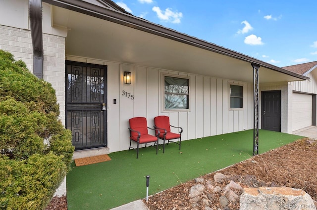 property entrance with board and batten siding and a porch