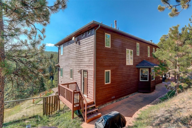 view of home's exterior featuring a wooden deck