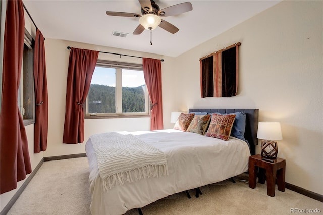 bedroom featuring light carpet and ceiling fan