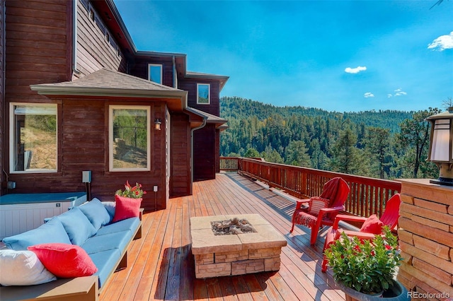 wooden deck with an outdoor living space with a fire pit