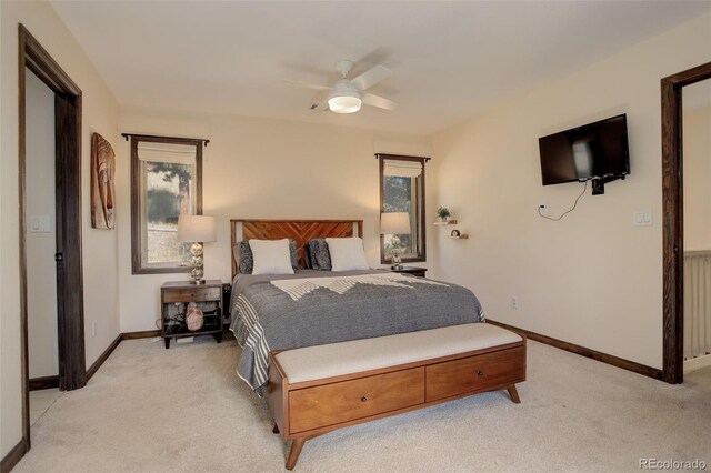 carpeted bedroom featuring radiator and ceiling fan