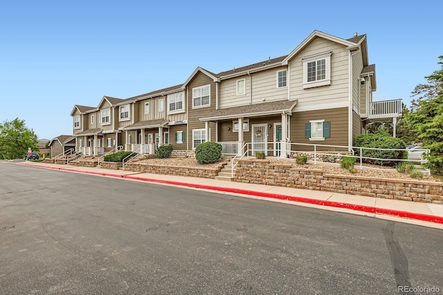 14700 E 104th Ave Unit 2802, Commerce City, CO 80022 - view of property with a residential view and covered porch