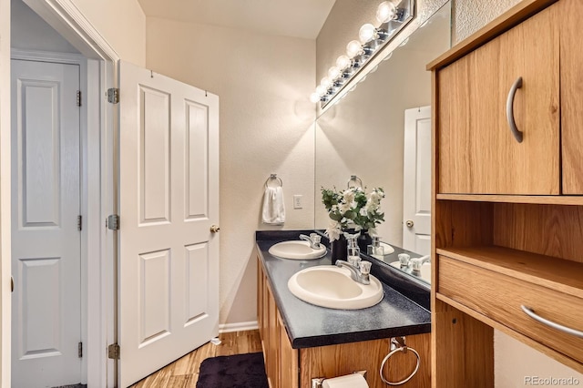 14700 E 104th Ave Unit 2802, Commerce City, CO 80022 - full bathroom featuring wood finished floors, double vanity, and baseboards