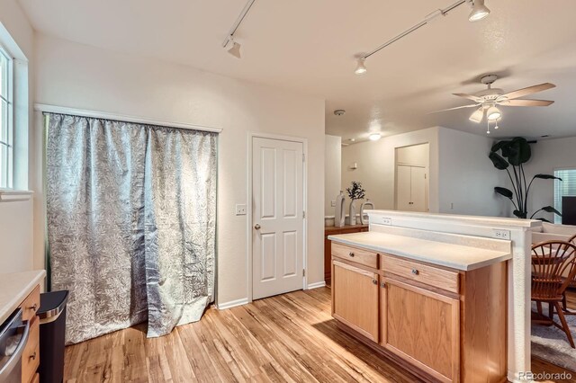 14700 E 104th Ave Unit 2802, Commerce City, CO 80022 - kitchen featuring rail lighting, ceiling fan, and light wood-style floors