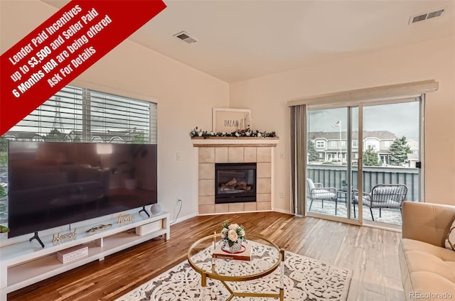 14700 E 104th Ave Unit 2802, Commerce City, CO 80022 - living area featuring wood finished floors and a tile fireplace