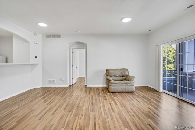 5255 Memphis St Unit 317, Denver, CO 80239 - unfurnished room with arched walkways, wood finished floors, and recessed lighting