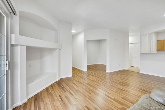 5255 Memphis St Unit 317, Denver, CO 80239 - unfurnished living room with light wood-type flooring and recessed lighting