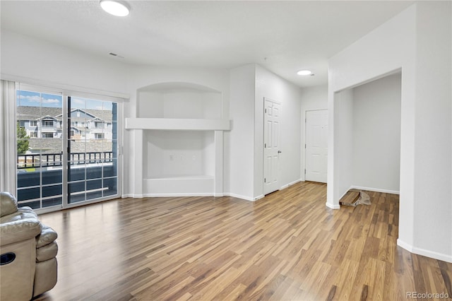 5255 Memphis St Unit 317, Denver, CO 80239 - unfurnished living room with wood finished floors and baseboards