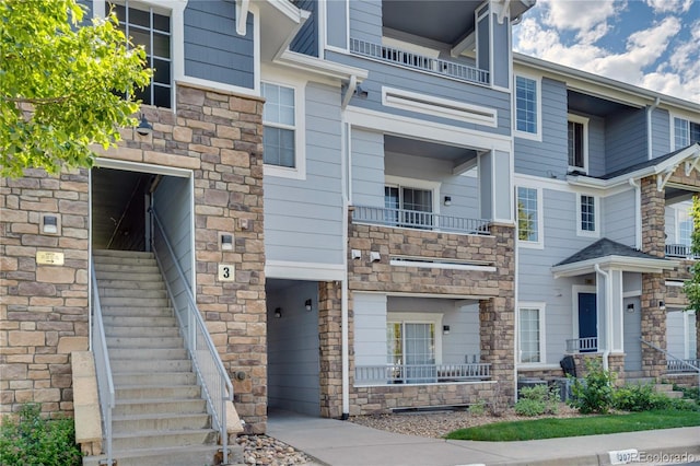 5255 Memphis St Unit 317, Denver, CO 80239 - view of front of house featuring stone siding and stairs