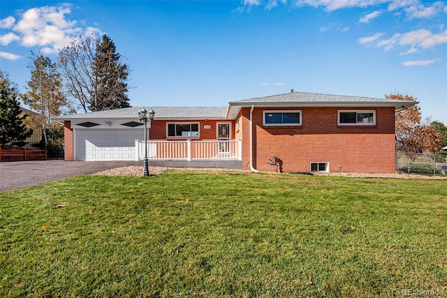 ranch-style home with a porch, a front yard, and a garage