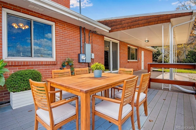 wooden deck featuring outdoor dining area