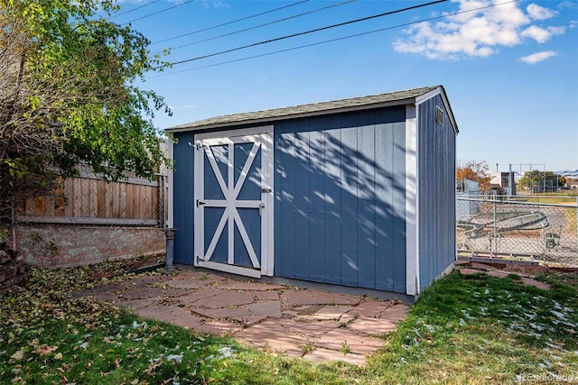 view of shed with fence