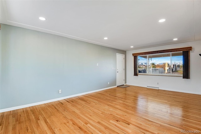 spare room with light wood-style floors, recessed lighting, baseboards, and baseboard heating