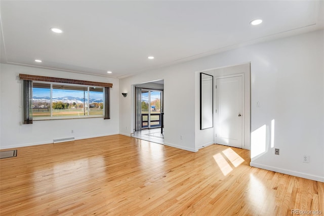 unfurnished room with recessed lighting, baseboards, light wood finished floors, and baseboard heating