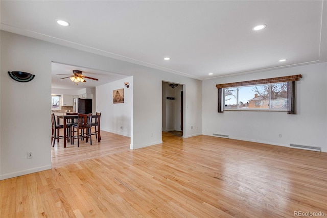 unfurnished living room with light wood-style flooring, recessed lighting, visible vents, a ceiling fan, and baseboards