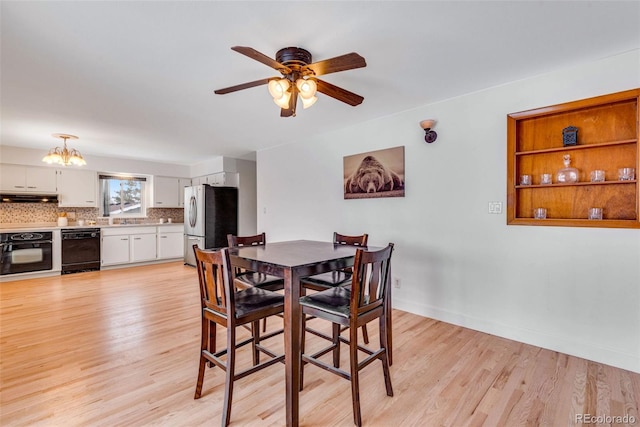 dining room featuring light wood-style floors, baseboards, and ceiling fan with notable chandelier