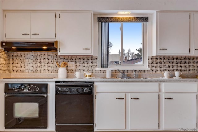 kitchen featuring light countertops, premium range hood, black appliances, and white cabinetry