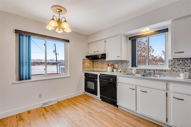 kitchen featuring visible vents, hanging light fixtures, light countertops, black appliances, and white cabinetry