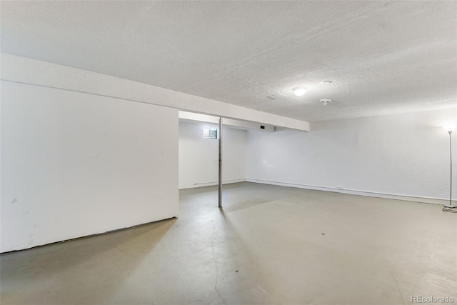 finished basement featuring a textured ceiling