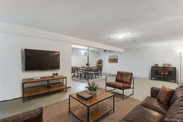 living area with concrete flooring