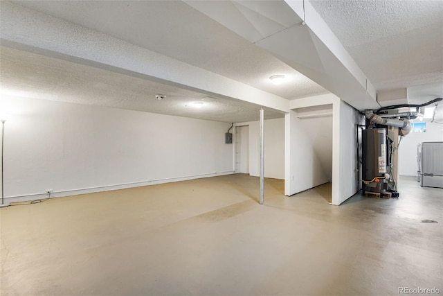 finished basement with washer / dryer, gas water heater, and a textured ceiling