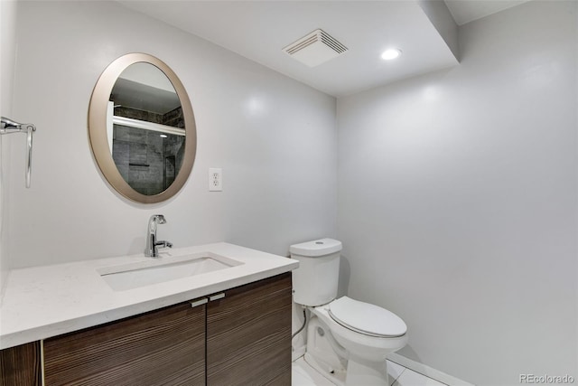 full bath featuring toilet, a shower with shower door, vanity, and visible vents