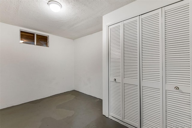 basement featuring a textured ceiling