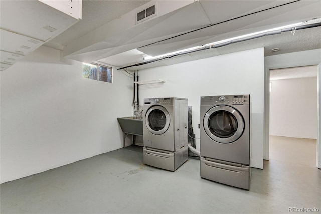 laundry room featuring laundry area, independent washer and dryer, a sink, and visible vents