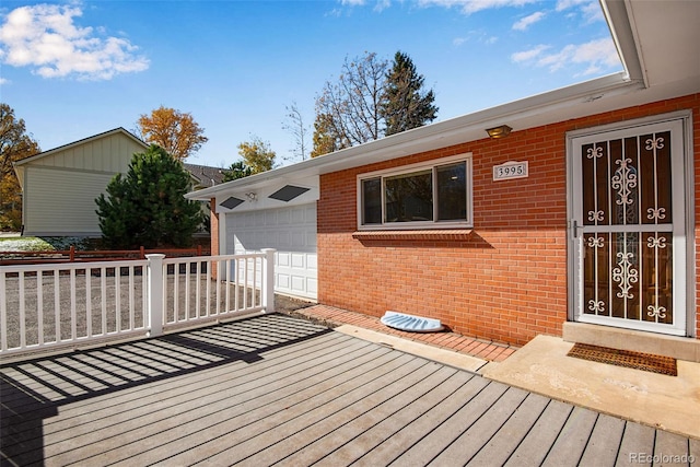 wooden deck featuring an attached garage