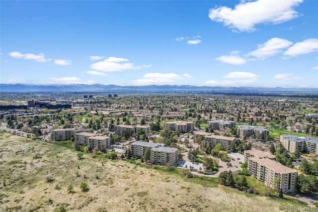 drone / aerial view featuring a city view and a mountain view