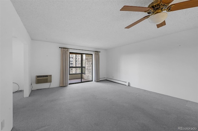 carpeted spare room featuring an AC wall unit, a textured ceiling, ceiling fan, and baseboard heating