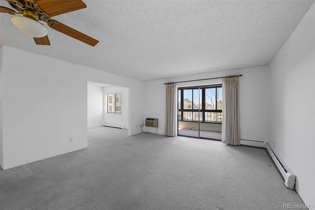 carpeted spare room with ceiling fan, baseboard heating, a wall mounted air conditioner, a textured ceiling, and a baseboard radiator