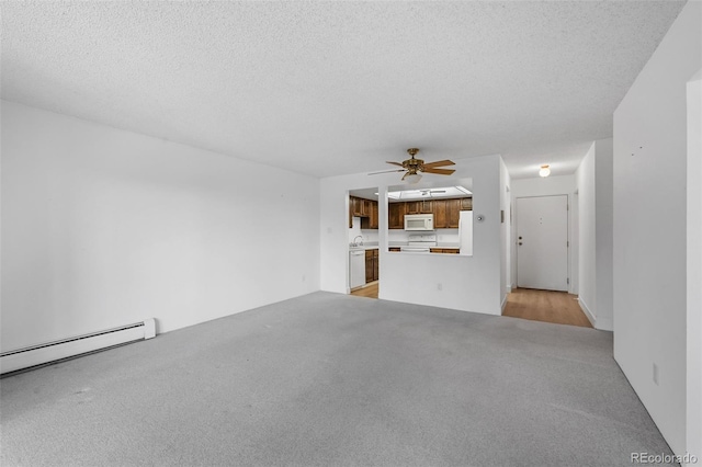 unfurnished living room featuring light carpet, a sink, a textured ceiling, a ceiling fan, and a baseboard heating unit