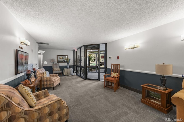 living room featuring a textured ceiling and carpet