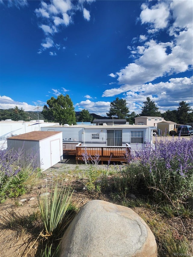 rear view of house featuring a deck